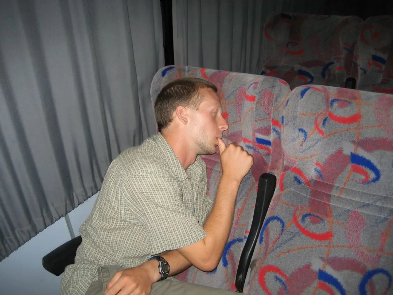 In this image there is a person laying on the chair, and in the background there are chairs and...