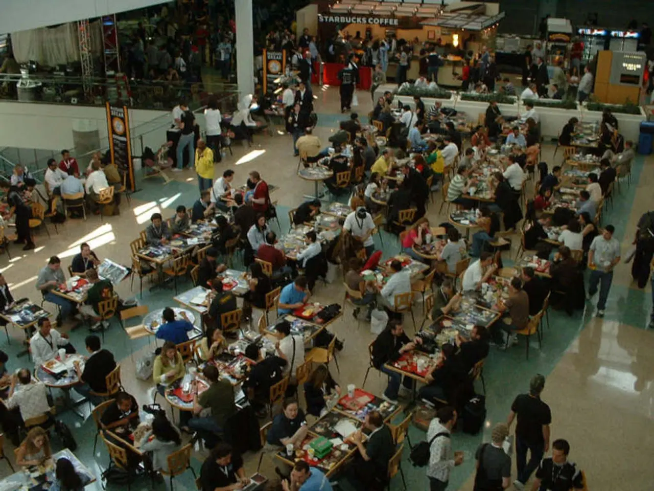 In this picture we can see the view of the restaurant. In the front there are men and women sitting...