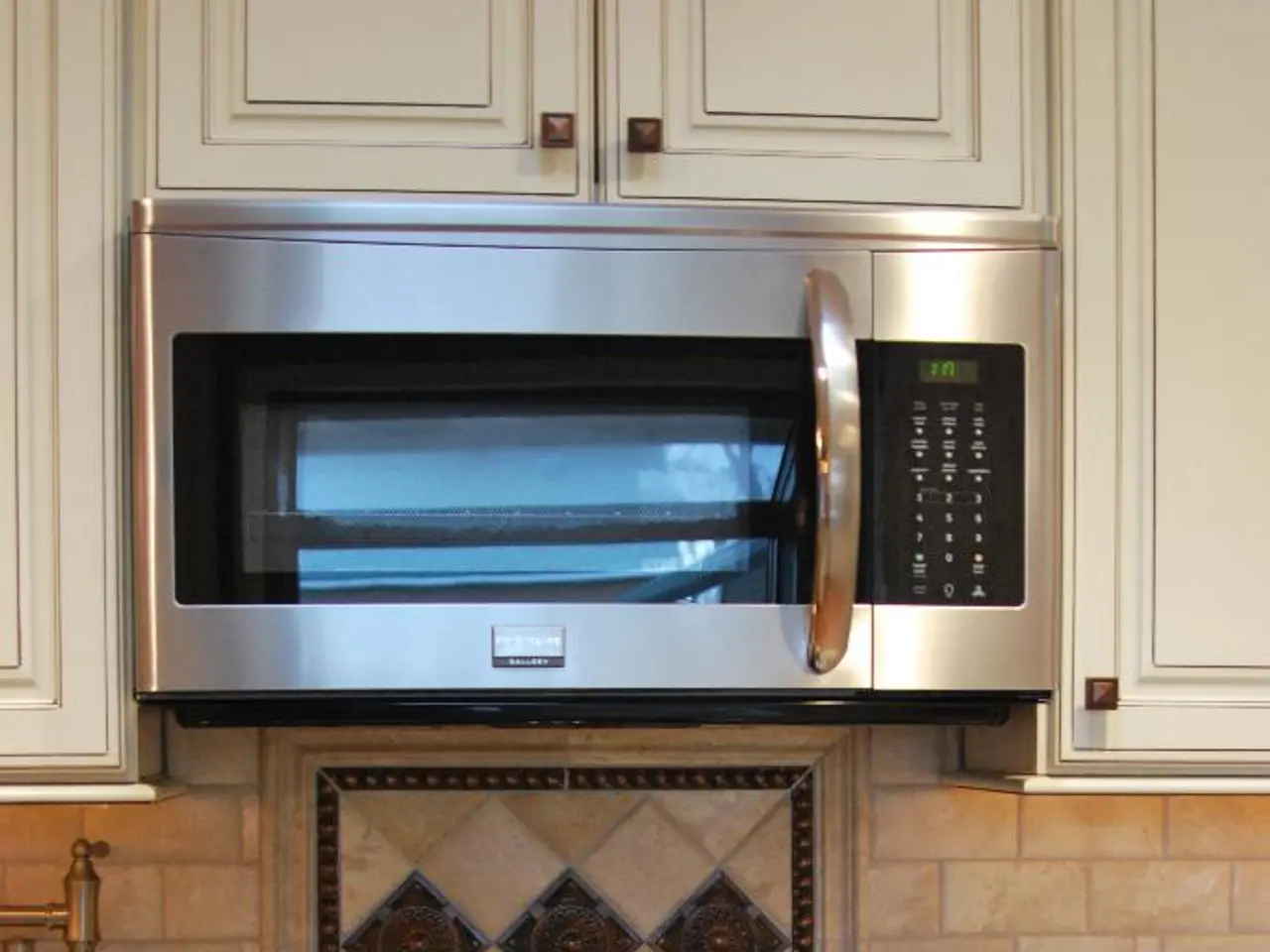 This image is taken in the kitchen. In the center of the image there is a kettle placed on the...