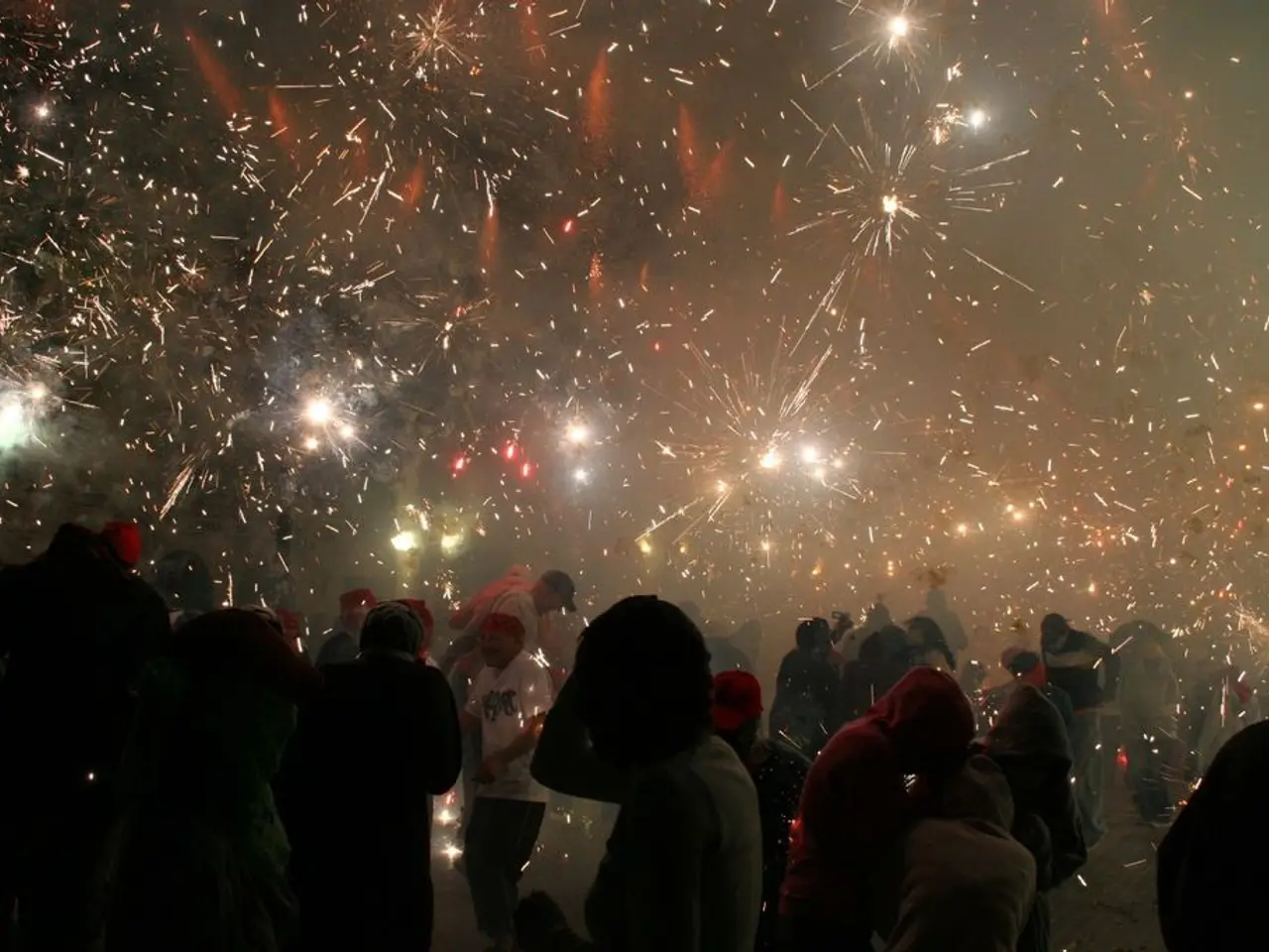 In this image we can see so many people are standing and they are burning crackers.