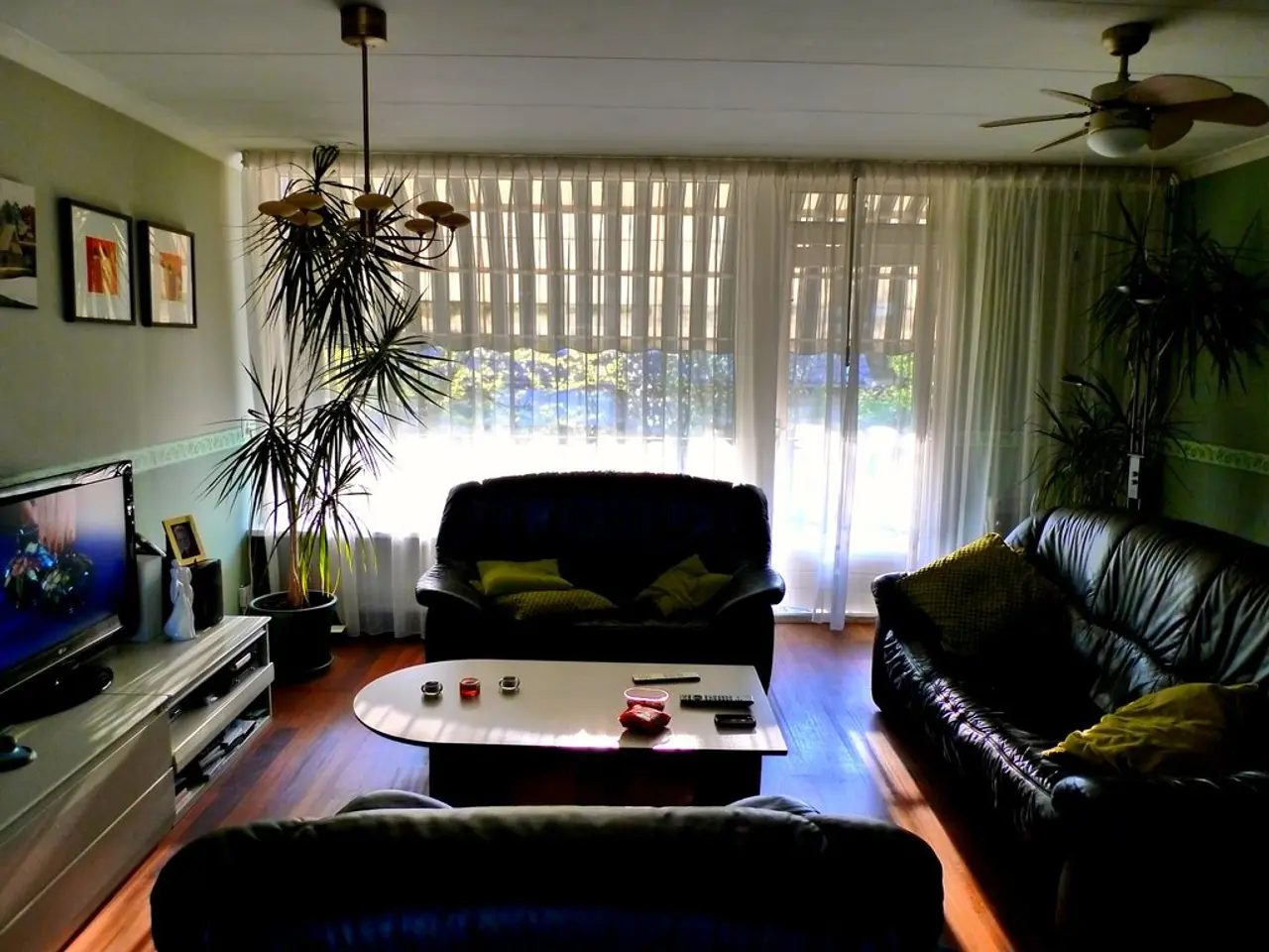 It is a closed room in which there are three sofas are present in centre of the room and one table...