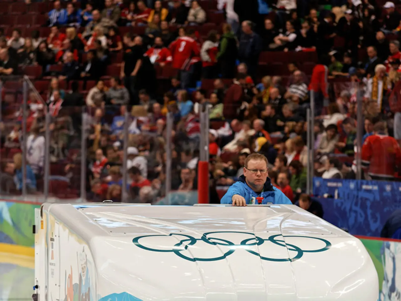 In this picture there is a man who is wearing blue jacket and spectacle. He is standing on the...
