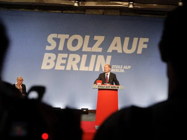 On the left side, there is a person. On the right side, there is a person. In the background, there...