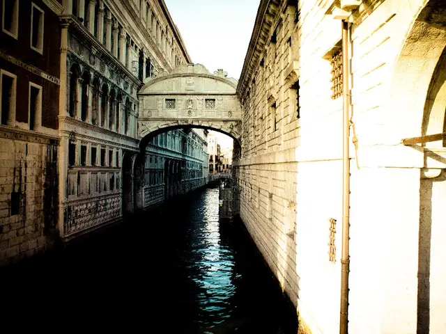 In this picture there is water and there are buildings on either sides of it.