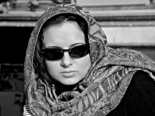 This is a black and white image. In this image we can see women wearing spectacles.