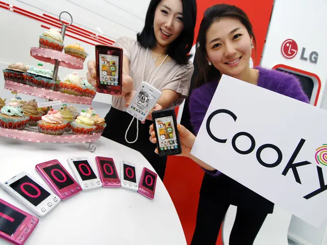 Two men are showing mobile phone named cooky on sale of ten lac pieces with some cookies beside...