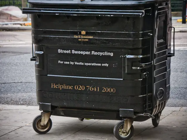 In the center of the image there is a black color dustbin. At the bottom of the image there is...