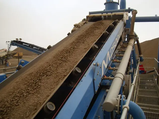 In the center of the image, we can see a machine and in the background, there is a vehicle and we...